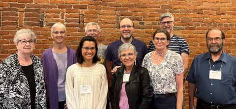 Nine members of board of directors, posing for formal photo.